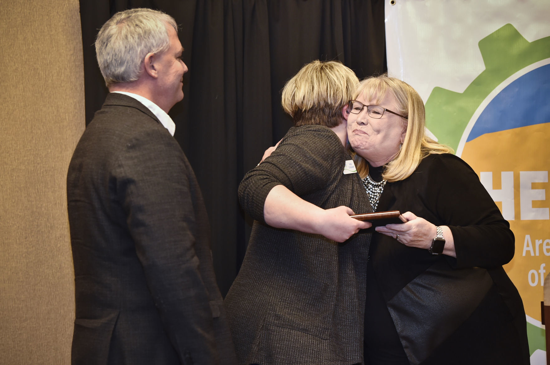 Cathy Burwell awards Kelly Creswell, center, and Kirk Lacy,